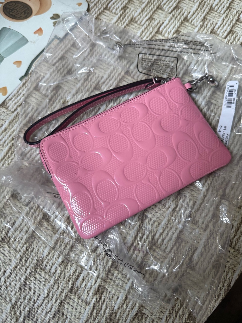 Coach pink leather wristlet with charm